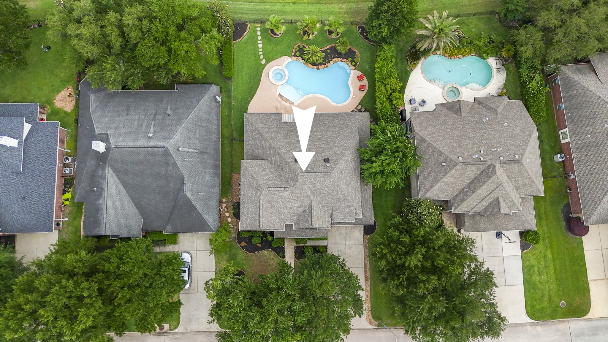 5835 Pinelake Crossing Drive Spring, TX 77379 - Photo 39 of 50 From above, you can see how everything comes together—from the expansive backyard and resort-style pool to the open stretch of golf course just beyond the fence. A newer roof adds peace of mind, while the overall layout highlights the space, privacy, and thoughtful improvements that carry throughout the home.