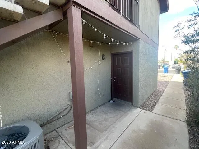 a kitchen with granite countertop white cabinets and refrigerator