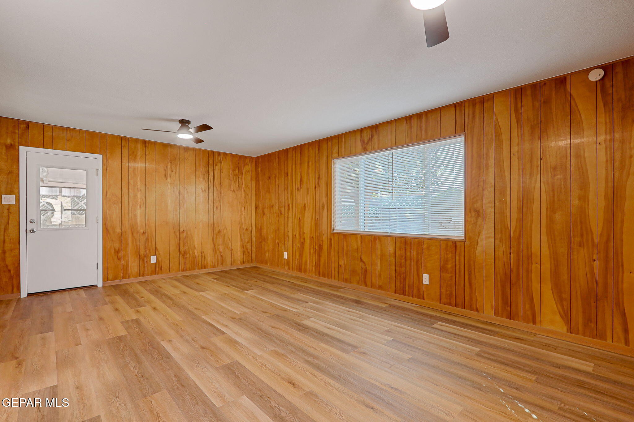 2801 Dunoon Drive El Paso, TX 79925 - Photo 17 of 41 an empty room with wooden floor and windows