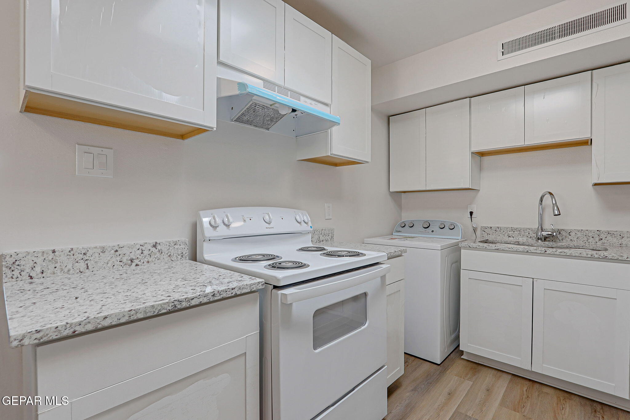 2801 Dunoon Drive El Paso, TX 79925 - Photo 20 of 41 a kitchen with granite countertop a sink a stove and cabinets