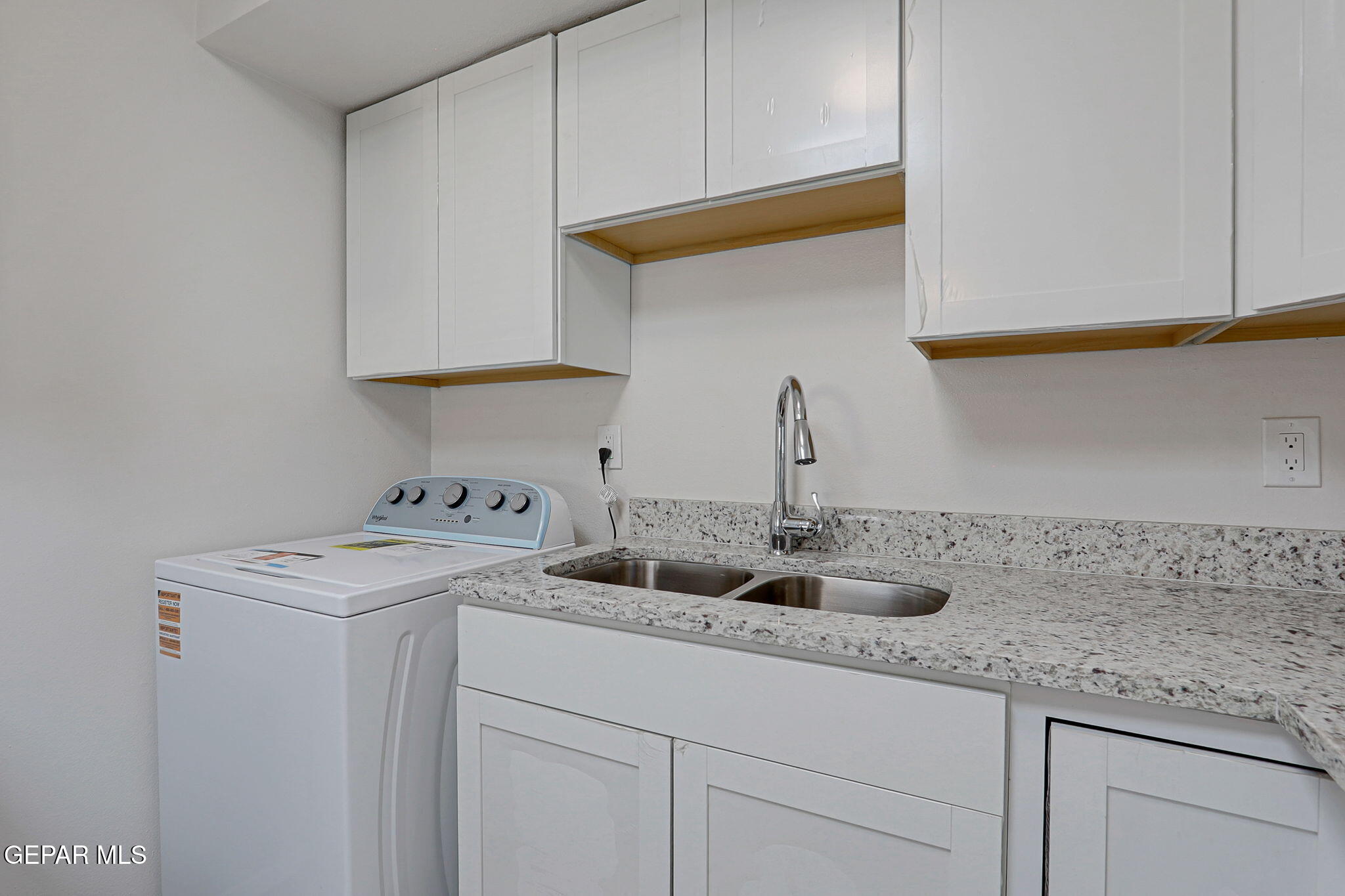 2801 Dunoon Drive El Paso, TX 79925 - Photo 21 of 41 a kitchen with stainless steel appliances granite countertop a sink and a white cabinets