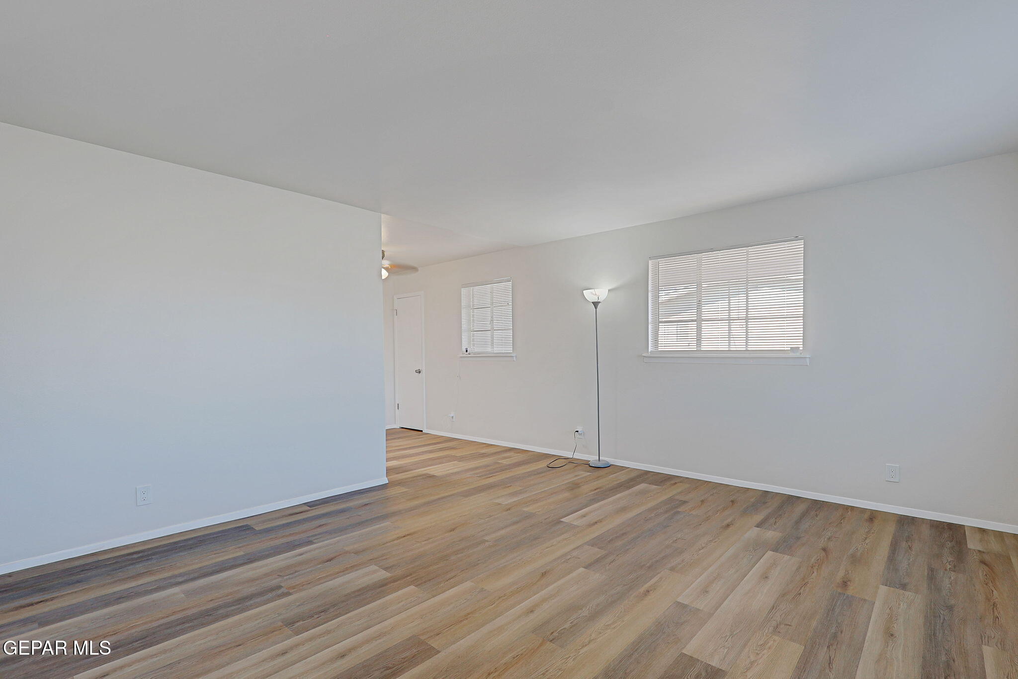 2801 Dunoon Drive El Paso, TX 79925 - Photo 28 of 41 an empty room with wooden floor and windows