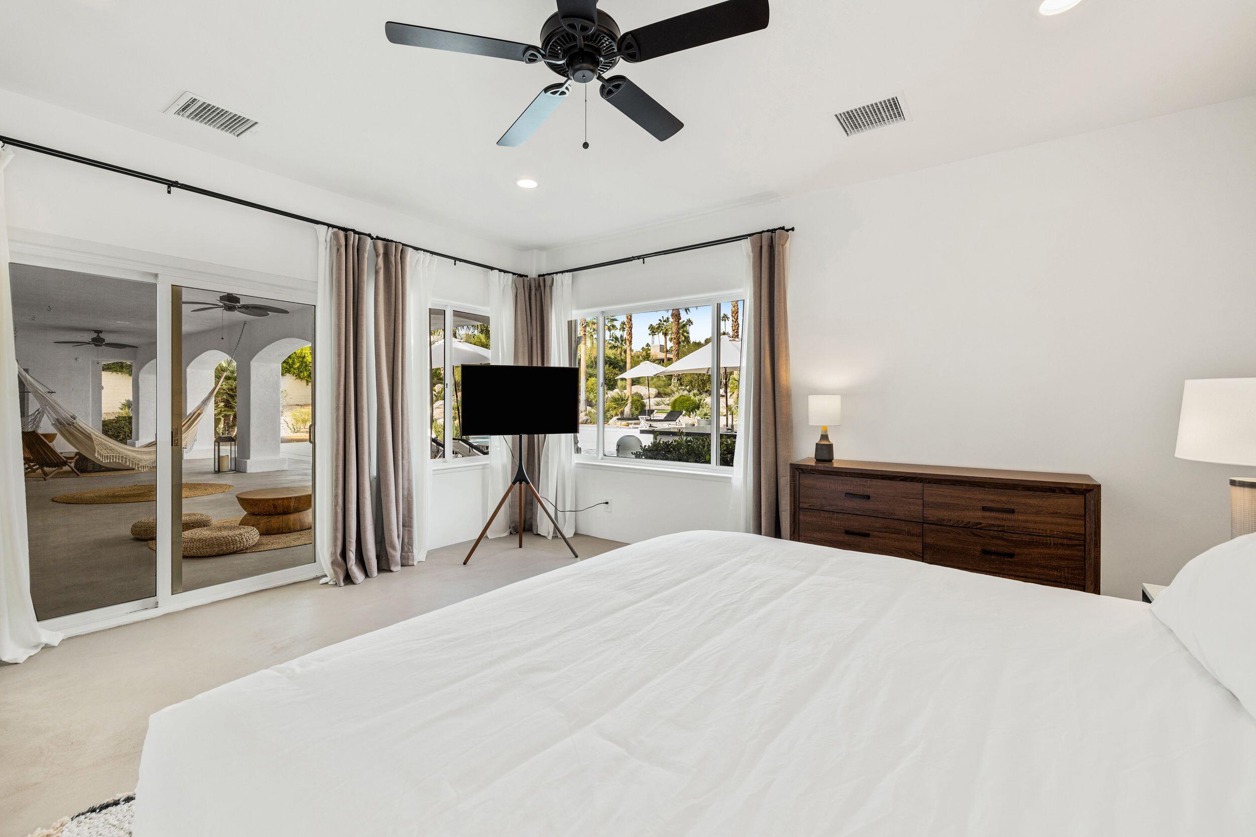 594 West Stevens Road Palm Springs, CA 92262 - Photo 12 of 28 a bedroom with a bed and a flat tv screen