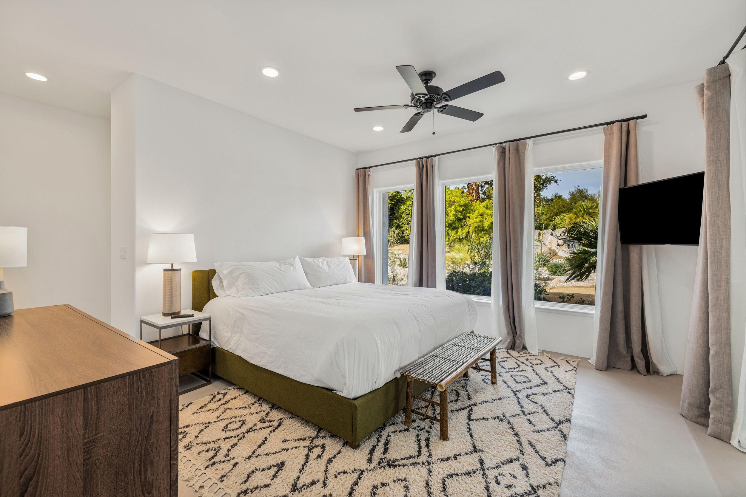 594 West Stevens Road Palm Springs, CA 92262 - Photo 14 of 28 a bedroom with a bed and a flat screen tv