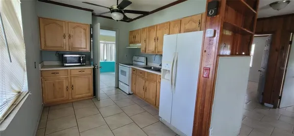 a kitchen with a refrigerator a stove top oven and a refrigerator