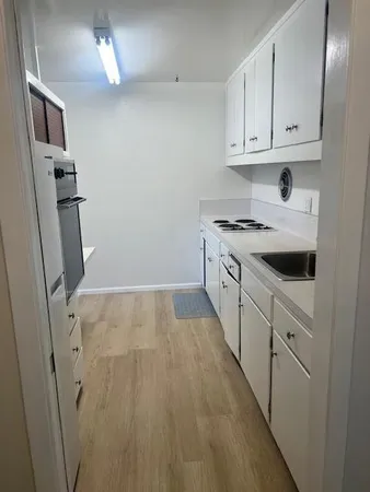 a kitchen with cabinets appliances and a counter space