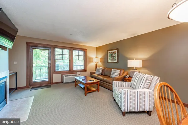 a living room with furniture and a large window