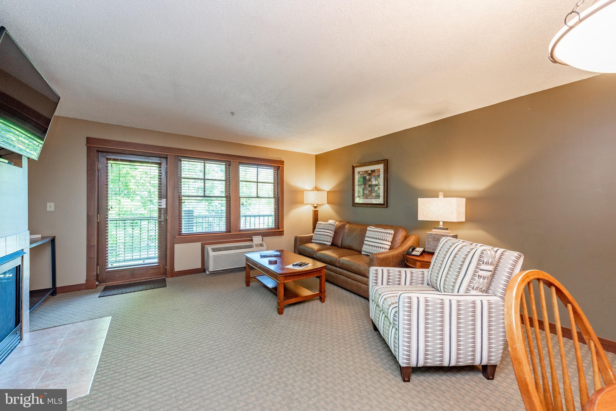 565 Glendale Road, Unit 106B Oakland, MD 21550 - Photo 8 of 27 a living room with furniture and a large window