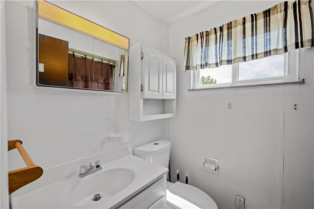 737 Railroad Street McKees Rocks, PA 15136 - Photo 9 of 17 a bathroom with a sink and mirror with toilet