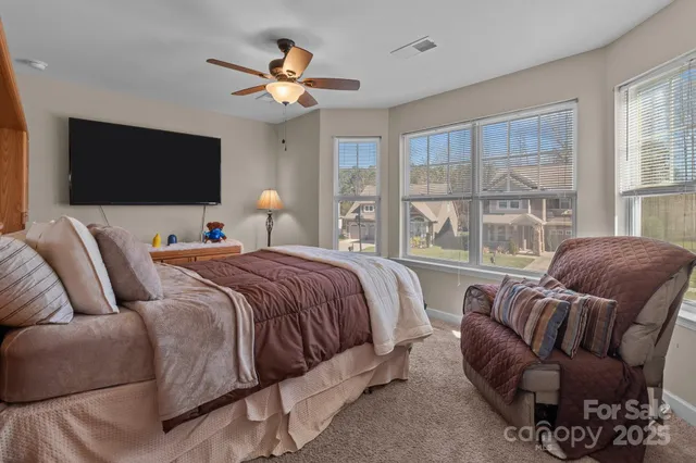 a bedroom with a bed couch and window