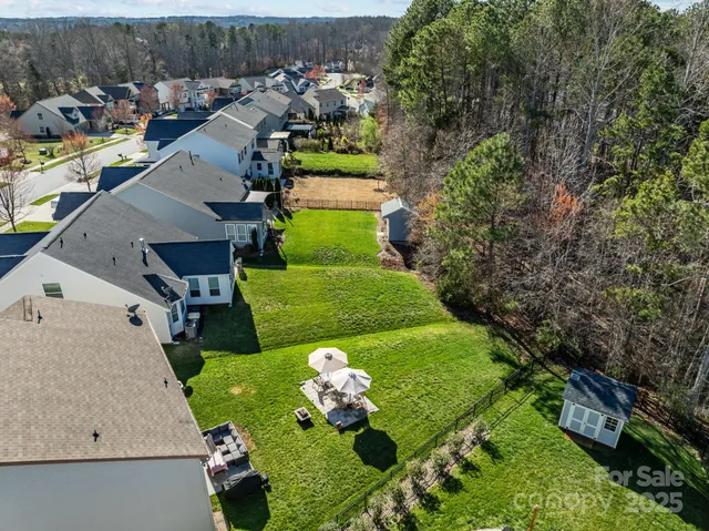 an aerial view of a house with yard swimming pool and outdoor seating