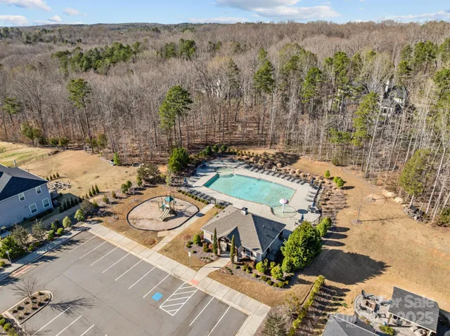 an aerial view of a house with yard
