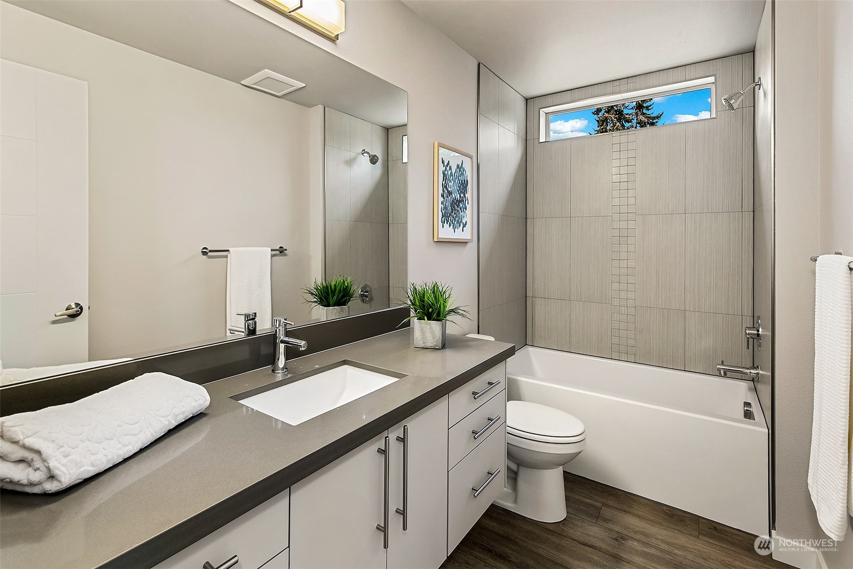 8435 22nd Avenue Southwest Seattle, WA 98106 - Photo 14 of 22 a bathroom with a granite countertop sink toilet a large mirror a bathtub and shower