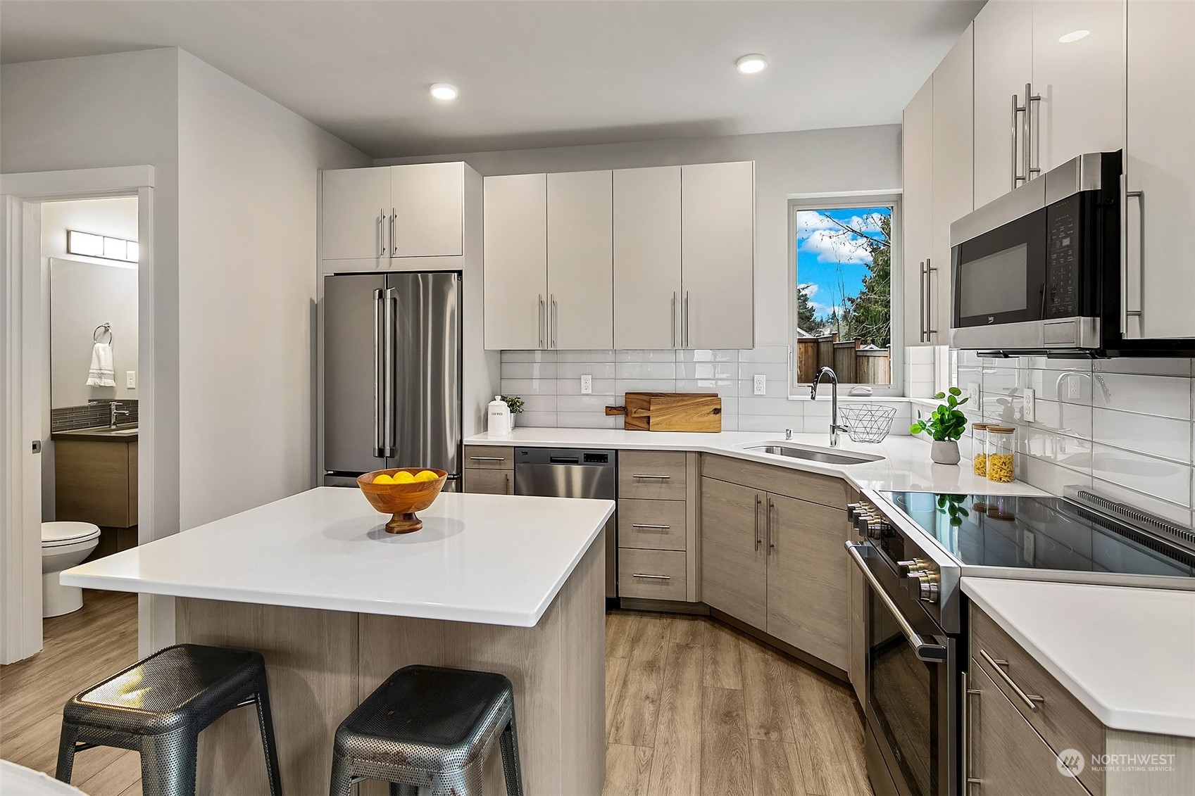 8435 22nd Avenue Southwest Seattle, WA 98106 - Photo 7 of 22 a kitchen with a sink a counter space appliances and cabinets