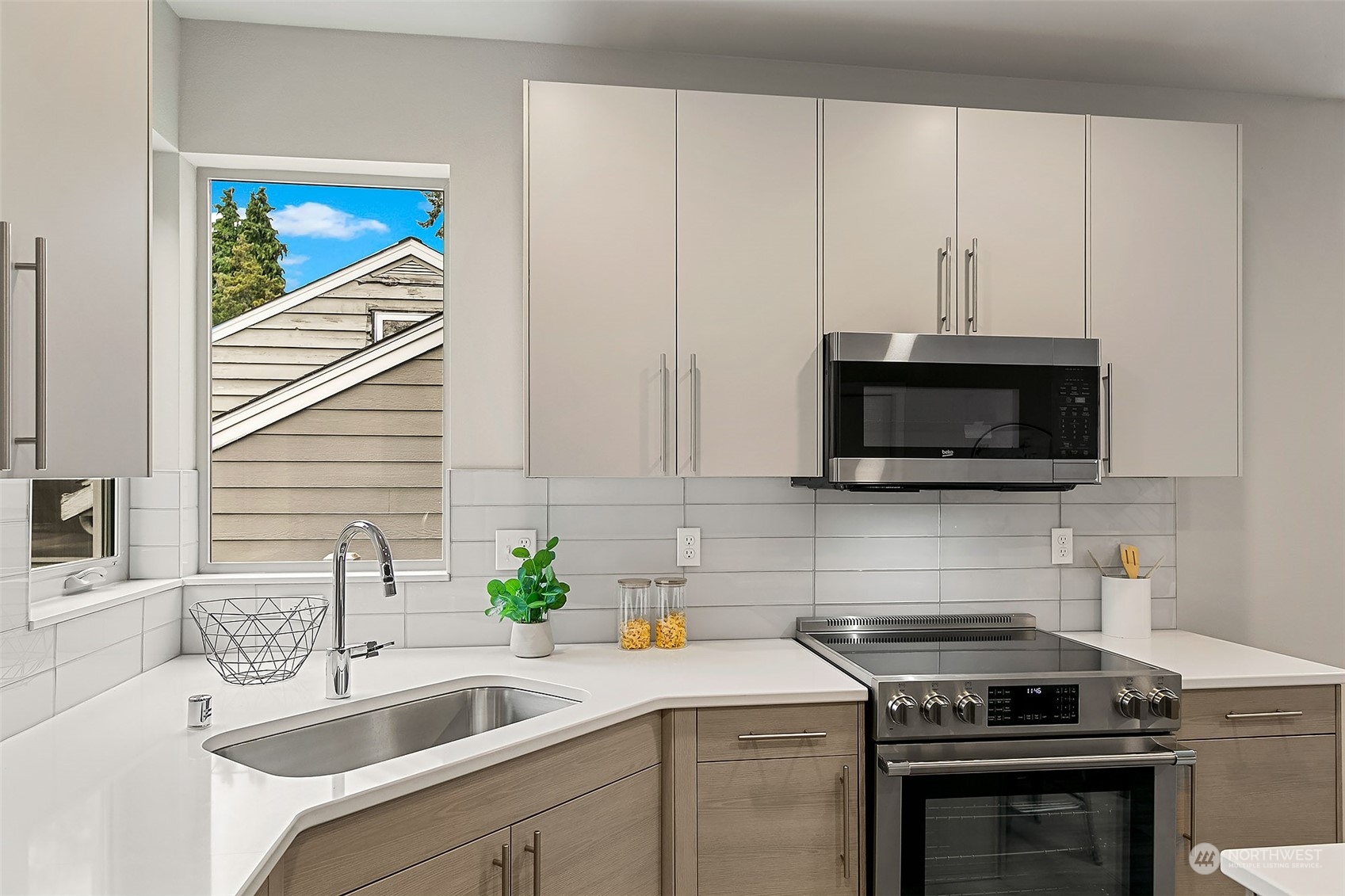 8435 22nd Avenue Southwest Seattle, WA 98106 - Photo 8 of 22 a kitchen with a sink stove and microwave