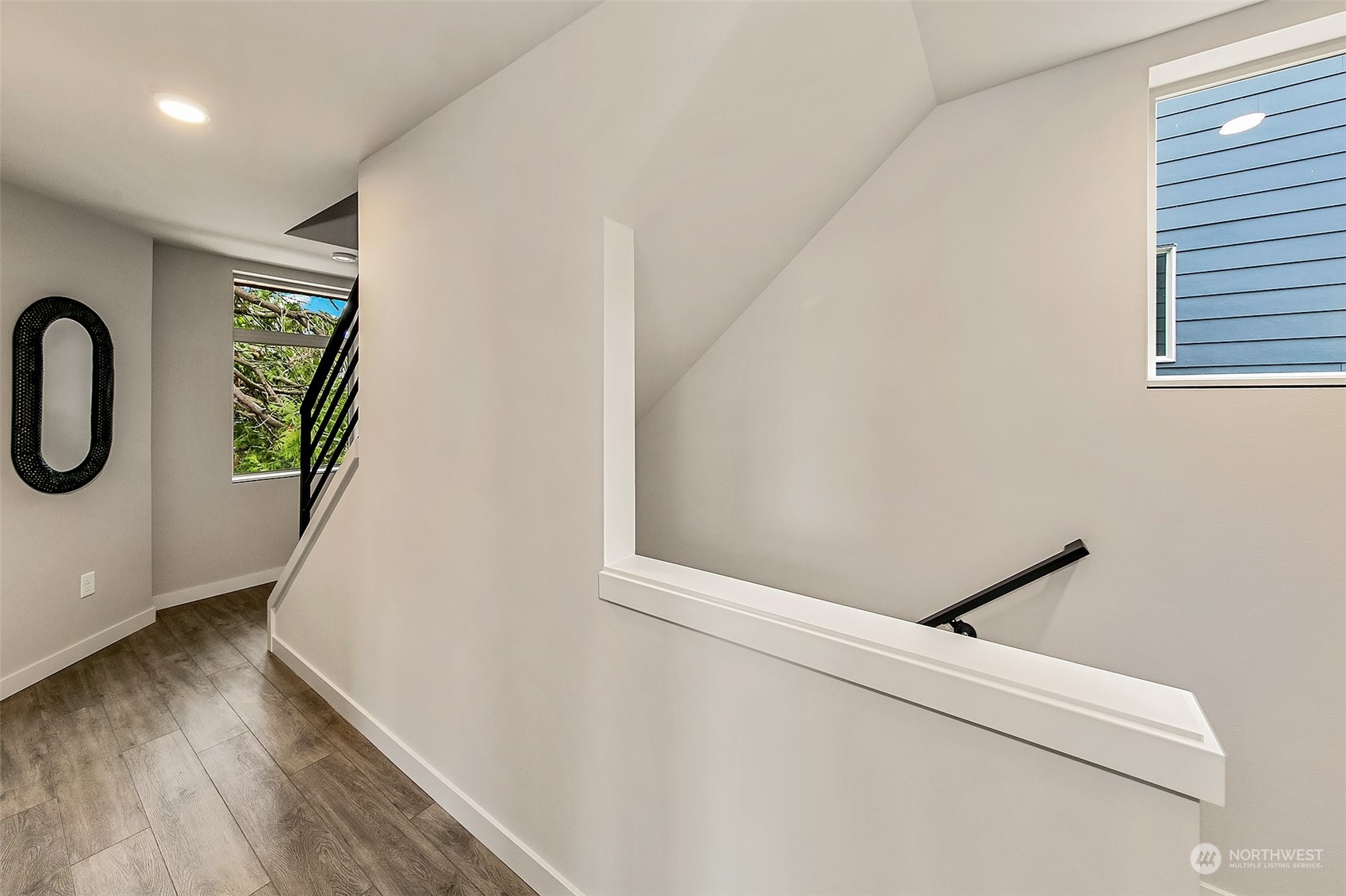 8435 22nd Avenue Southwest Seattle, WA 98106 - Photo 9 of 22 a hallway with stairs and wooden floor
