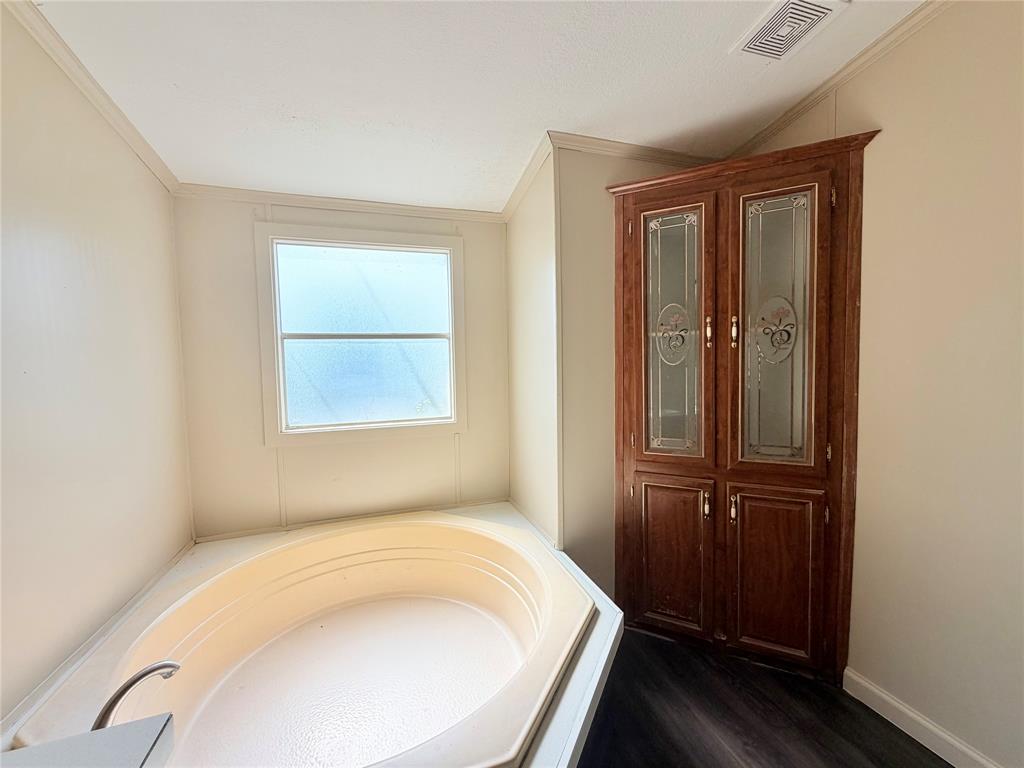 9721 Limestone Joshua, TX 76058 - Photo 22 of 36 a bathroom with a bathtub and a window