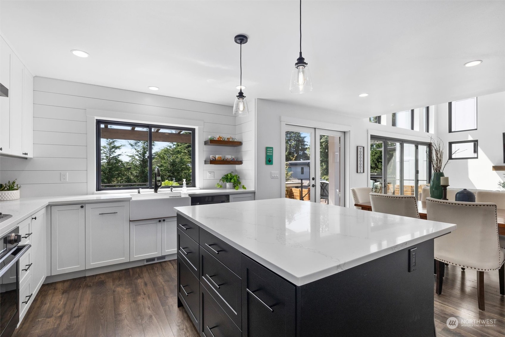 331 8th Avenue Kirkland, WA 98033 - Photo 4 of 40 a large kitchen with kitchen island a large counter space windows and stainless steel appliances