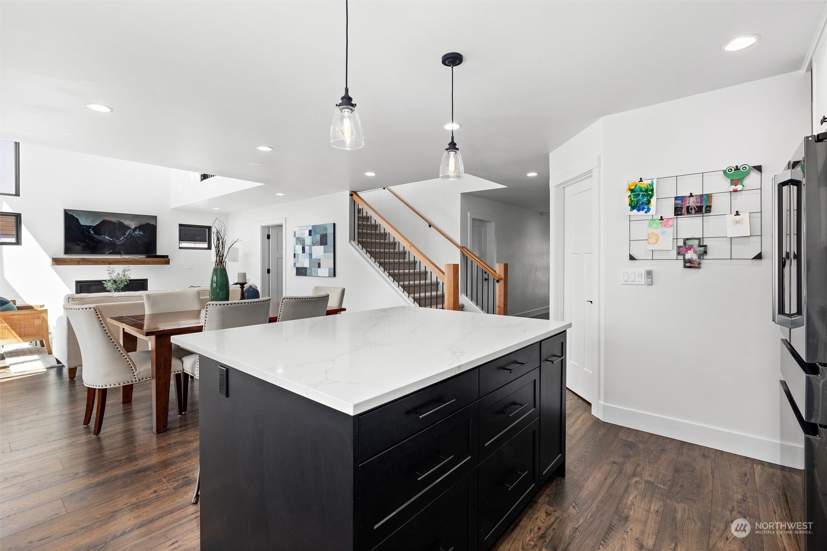 331 8th Avenue Kirkland, WA 98033 - Photo 8 of 40 a kitchen with stainless steel appliances a stove a refrigerator and a dining table with wooden floor