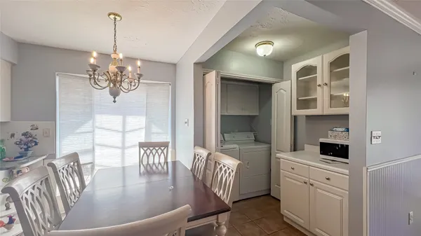 a dining room with furniture a livingroom and chandelier