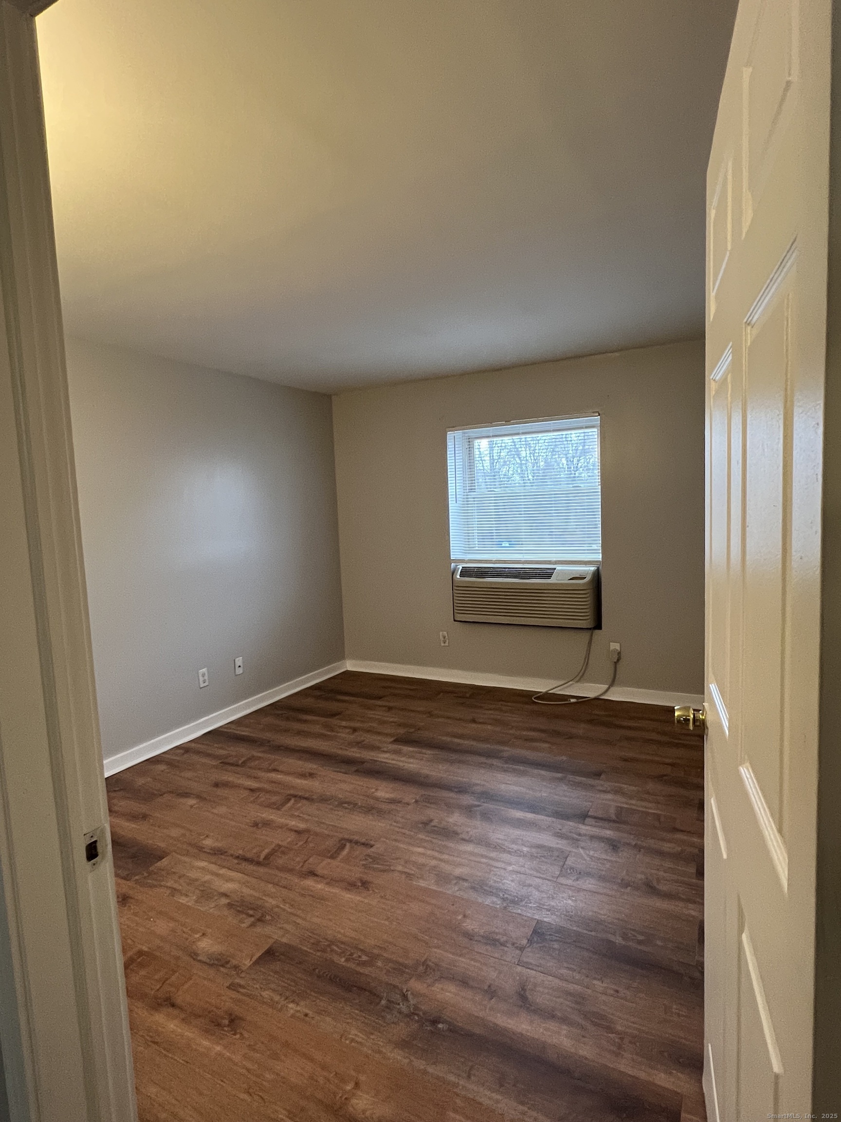 385 Putnam Avenue, Unit 35 Hamden, CT 06517 - Photo 11 of 17 a view of an empty room and window