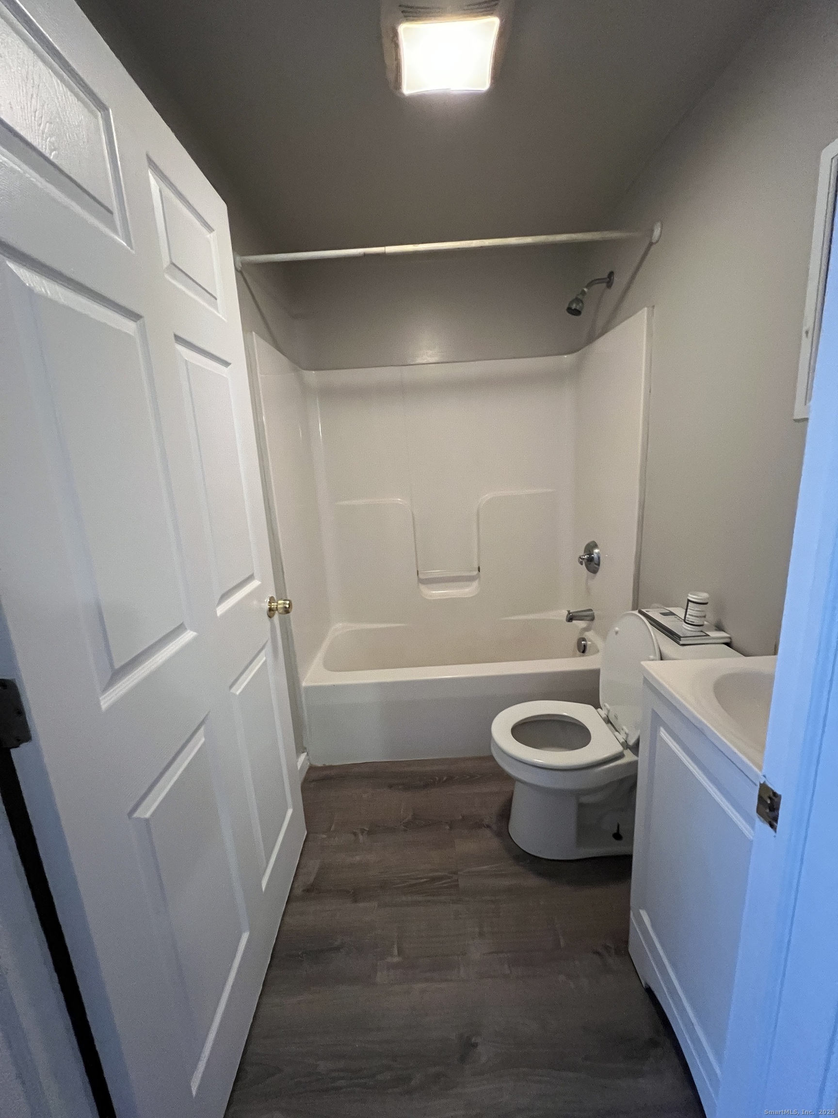 385 Putnam Avenue, Unit 35 Hamden, CT 06517 - Photo 14 of 17 a bathroom with a sink a toilet and shower
