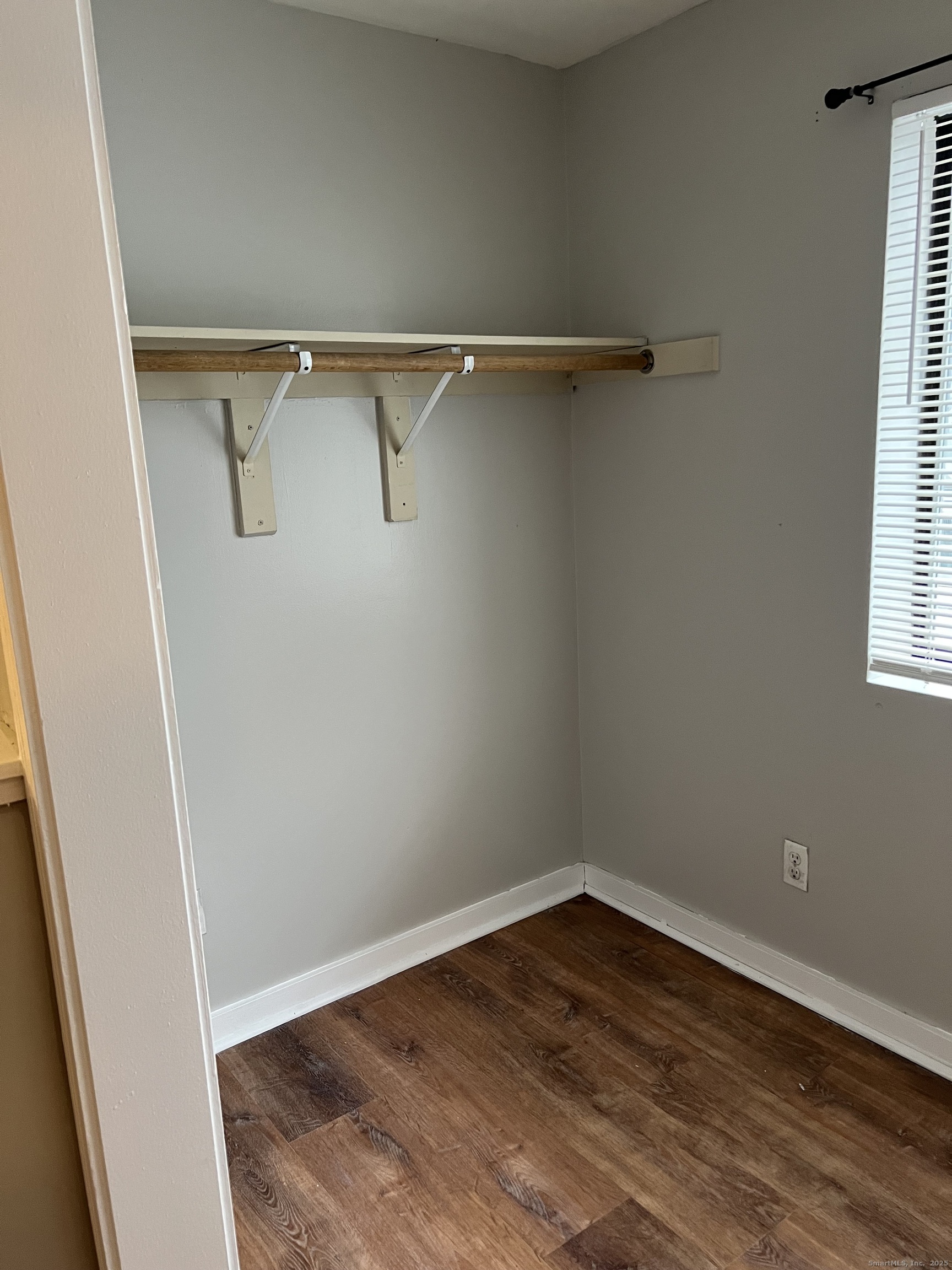 385 Putnam Avenue, Unit 35 Hamden, CT 06517 - Photo 16 of 17 a view of a room with wooden floor and windows