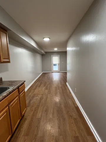 a view of an empty room with wooden floor