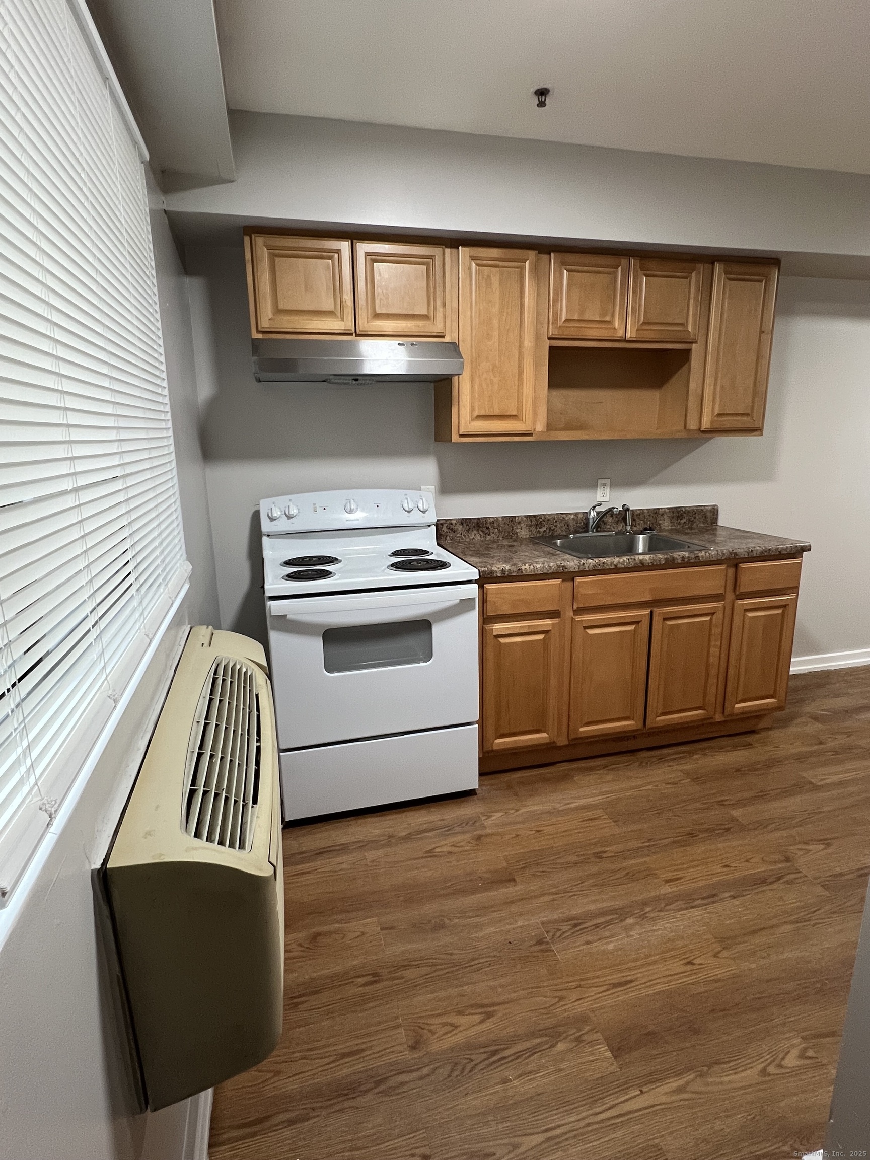 385 Putnam Avenue, Unit 35 Hamden, CT 06517 - Photo 8 of 17 a kitchen with stainless steel appliances granite countertop a stove a sink and a microwave