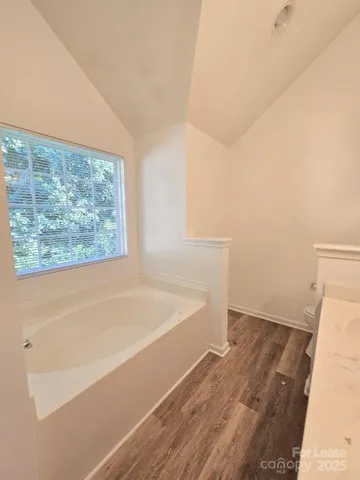 a bathroom with a bathtub and window