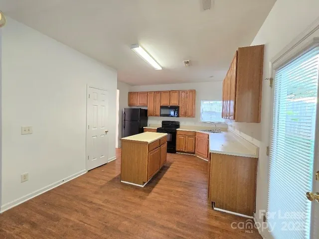 a kitchen with a refrigerator and a stove