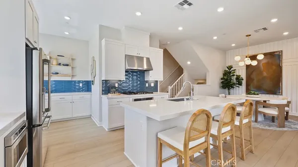 a large kitchen with a table and chairs