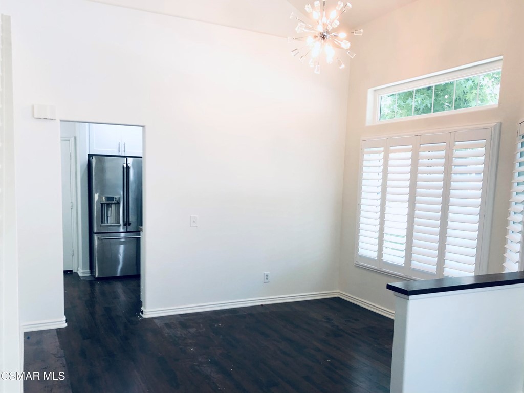 468 Pavarotti Drive Oak Park, CA 91377 - Photo 11 of 17 an empty room with wooden floor chandelier and windows