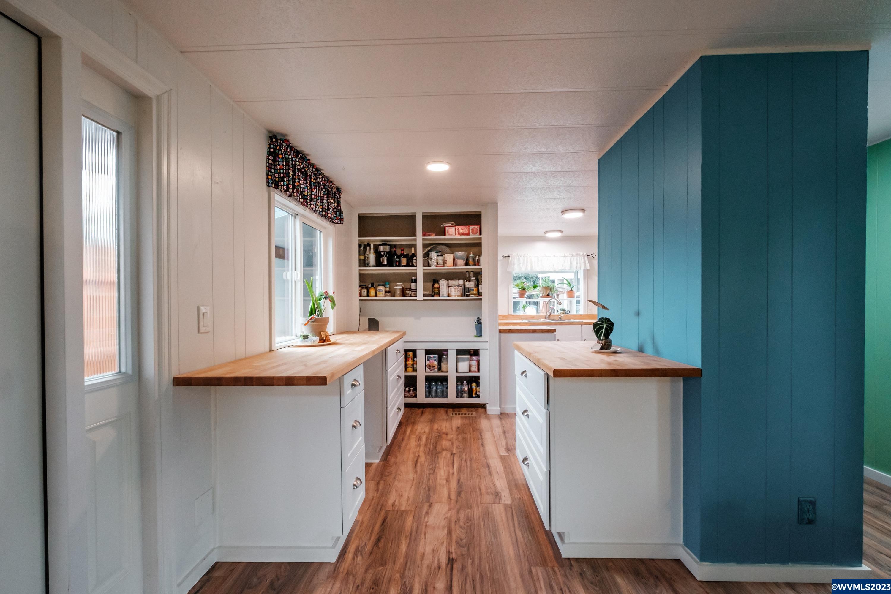 4915 Swegle Road Northeast, Unit 47 Salem, OR 97301 - Photo 14 of 36 a kitchen with kitchen island a counter top space a stove wooden floor and cabinets