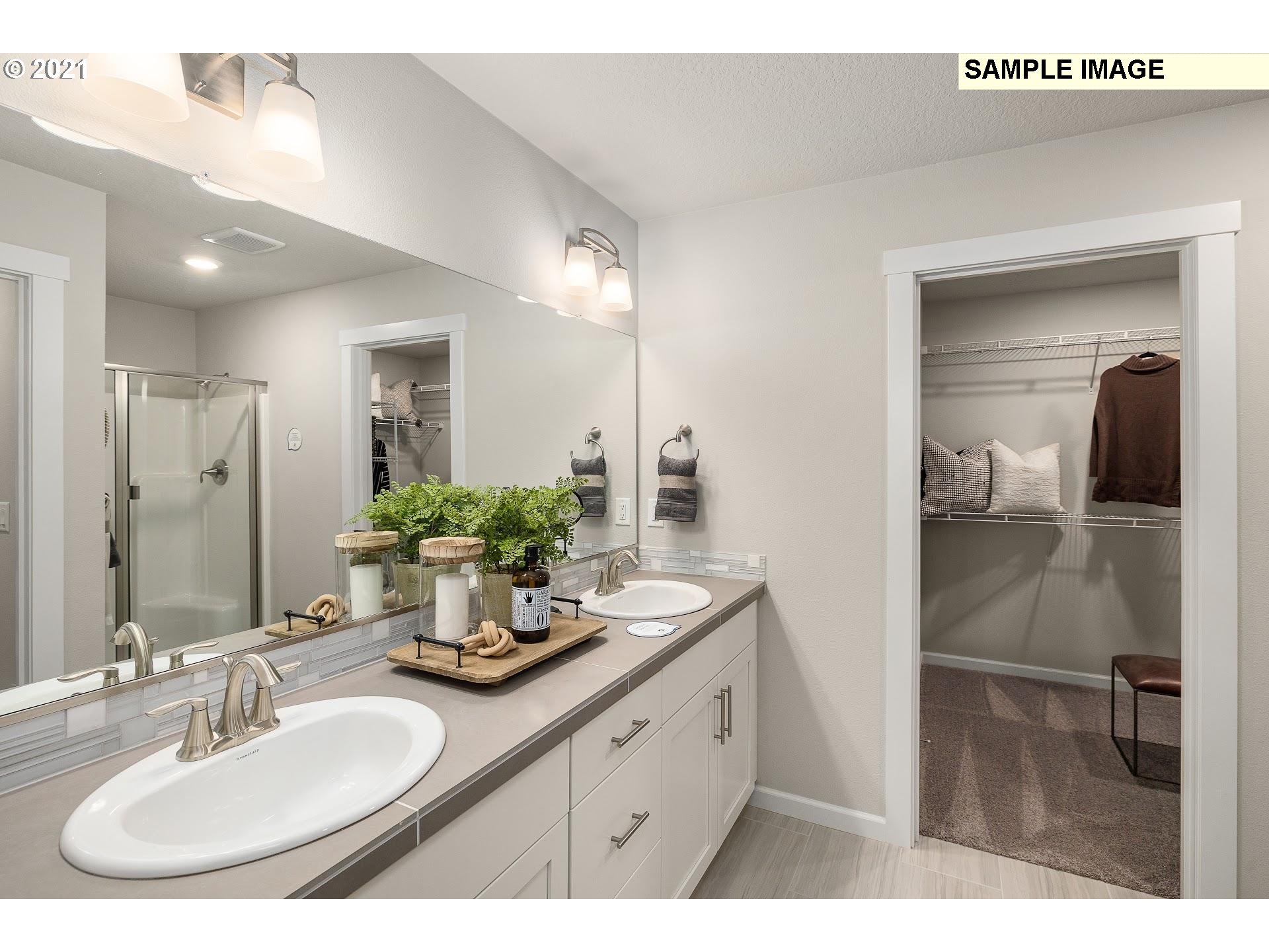 4260 South Laughing Water Circle Ridgefield, WA 98642 - Photo 14 of 24 a bathroom with a double vanity sink and a mirror