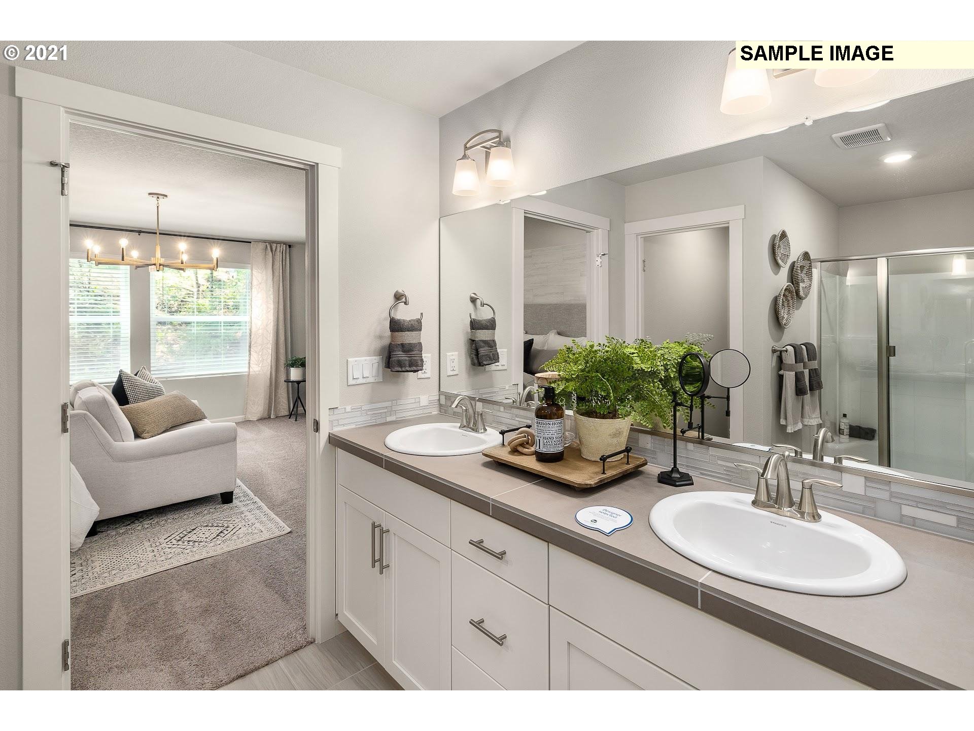 4260 South Laughing Water Circle Ridgefield, WA 98642 - Photo 15 of 24 a en suite bathroom with a granite countertop sink and a large mirror