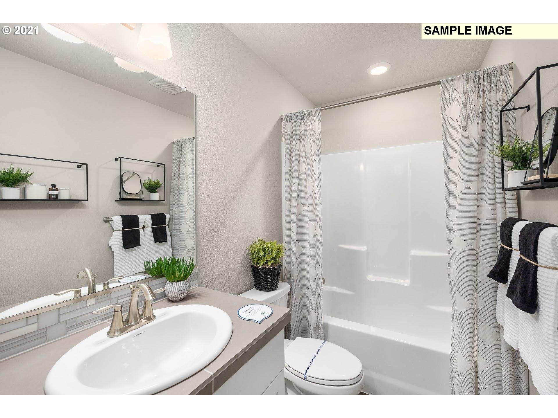 4260 South Laughing Water Circle Ridgefield, WA 98642 - Photo 17 of 24 a bathroom with a sink and a mirror