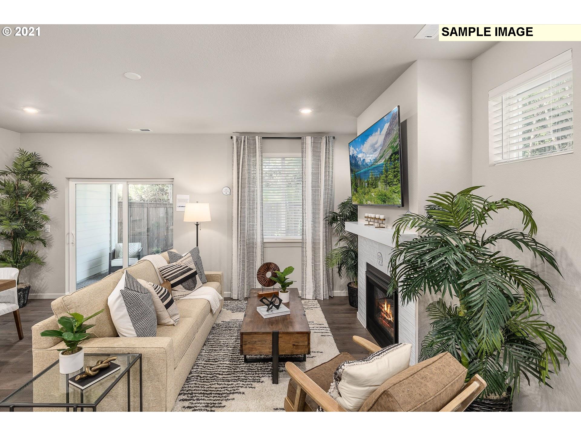 4260 South Laughing Water Circle Ridgefield, WA 98642 - Photo 5 of 24 a living room with furniture and a potted plant