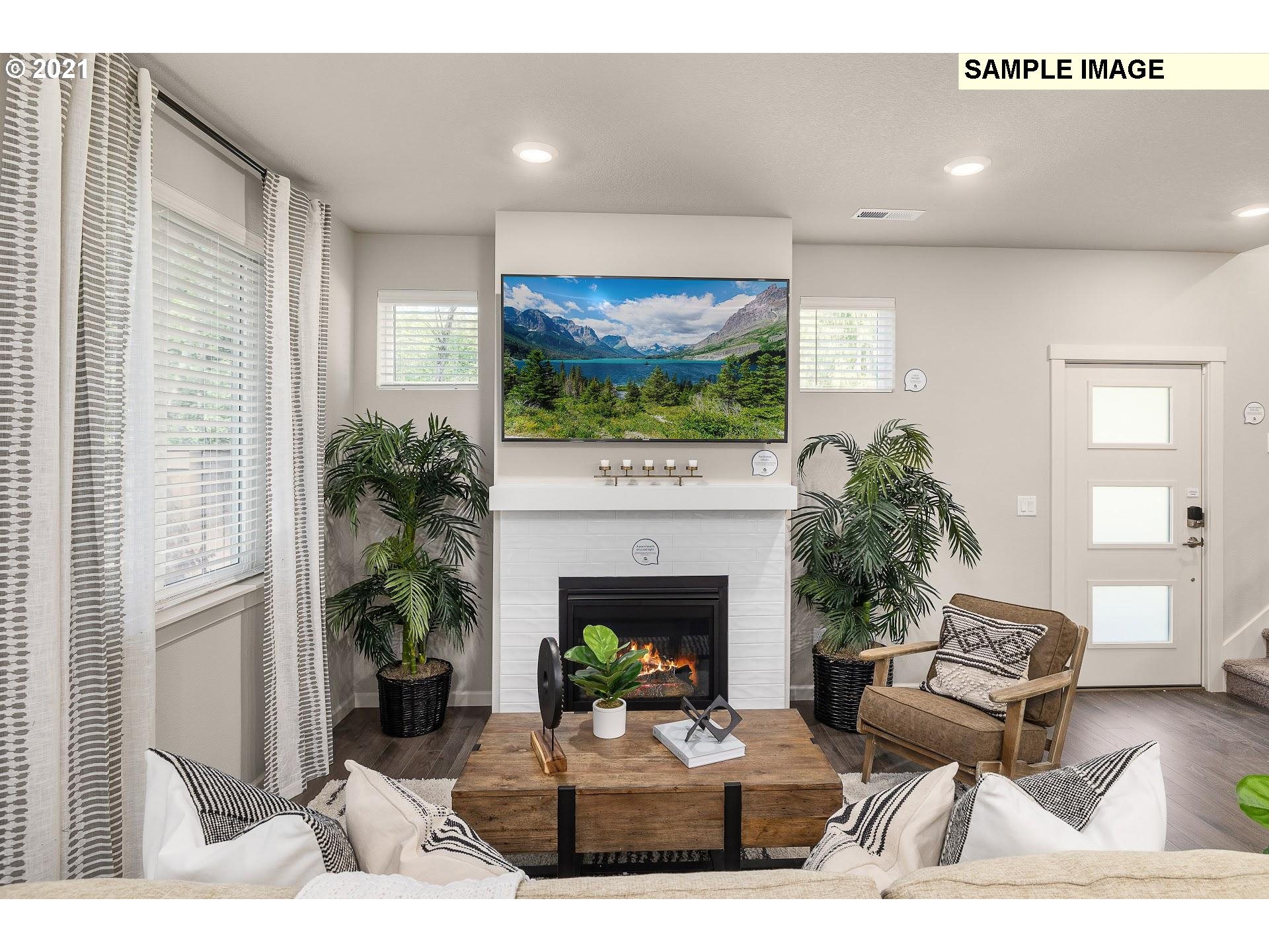 4260 South Laughing Water Circle Ridgefield, WA 98642 - Photo 7 of 24 a living room with furniture a fireplace and a flat screen tv