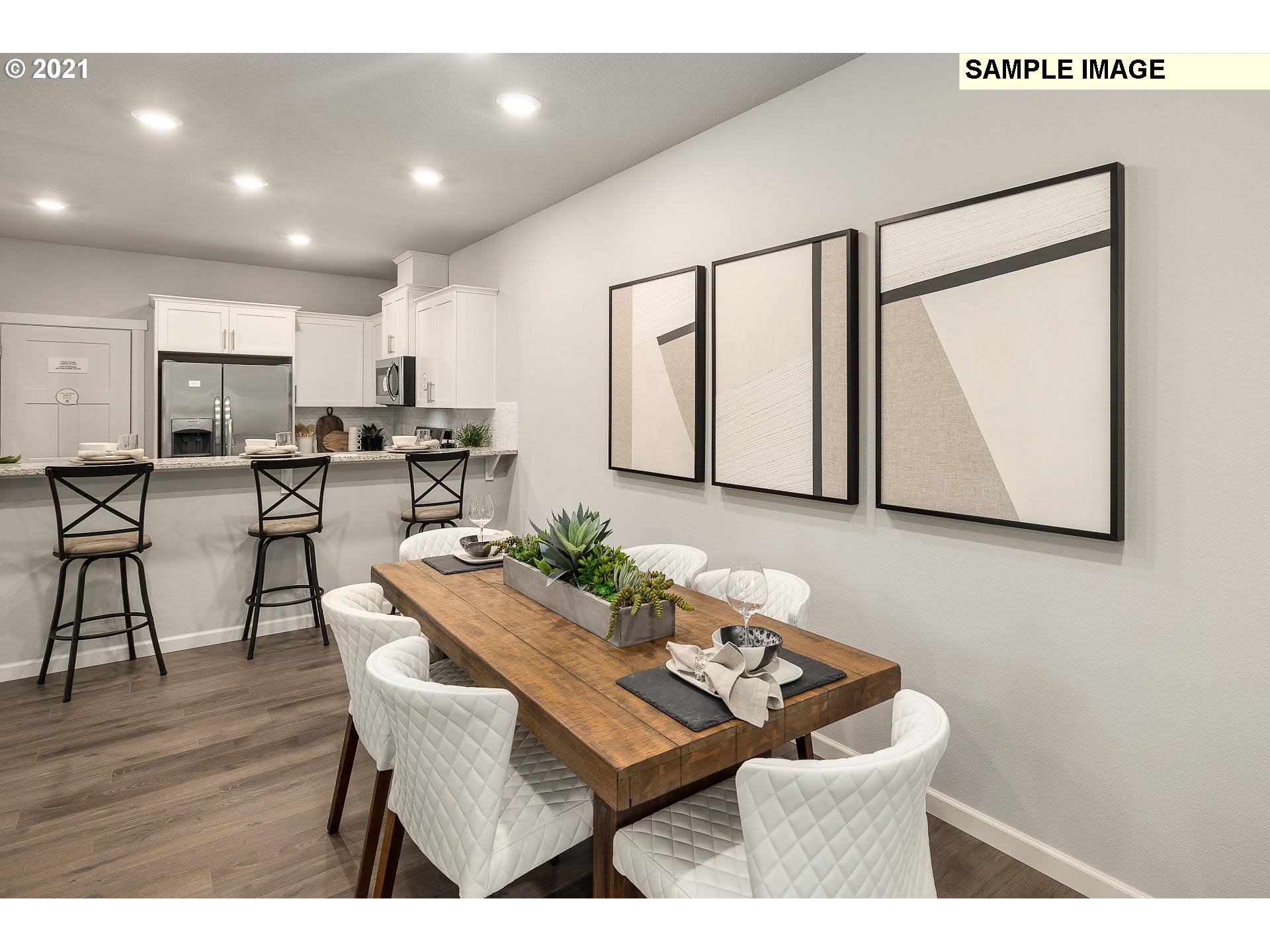 4260 South Laughing Water Circle Ridgefield, WA 98642 - Photo 9 of 24 a view of a dining room with furniture and wooden floor