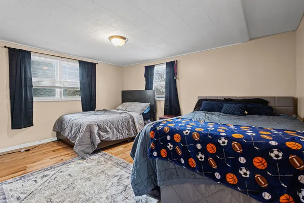 a bedroom with two beds and a large window