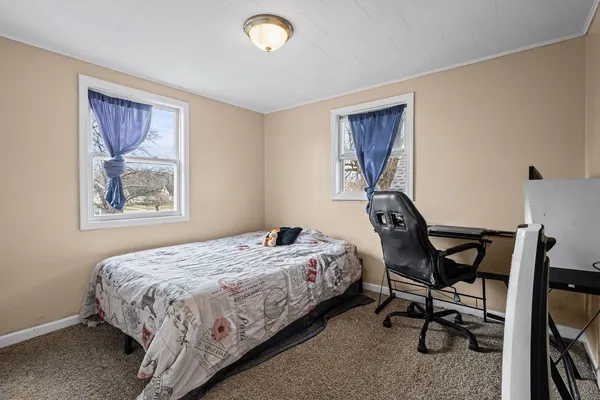 a bedroom with a bed and a desk