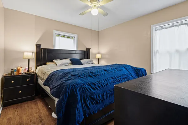 a bedroom with a bed and a chandelier