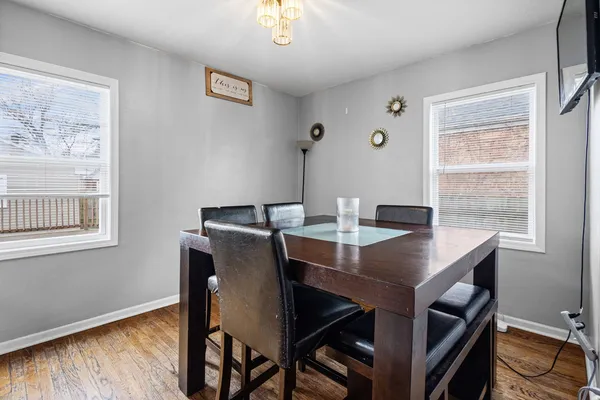a view of a dining room with a table and chairs