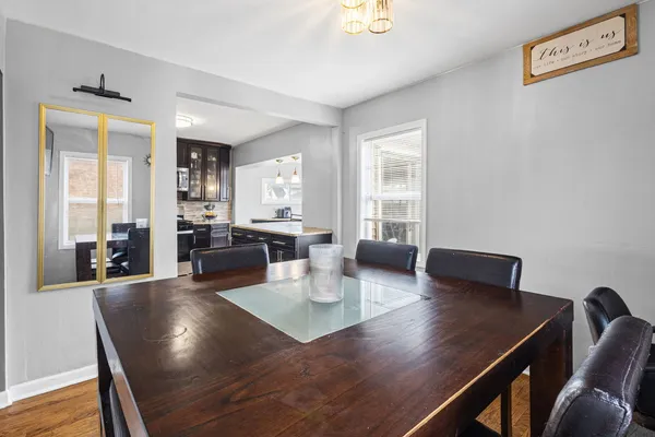 a view of a dining room with furniture and wooden floor