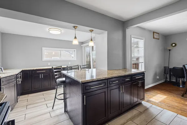 a kitchen with granite countertop a sink and cabinets