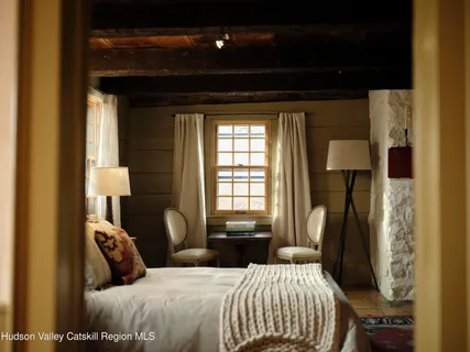 a view of an empty room with stairs and a window