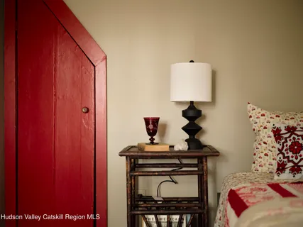 a aerial view of a house with yard and trees in the background