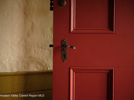 a view of a lush green forest with trees and some houses