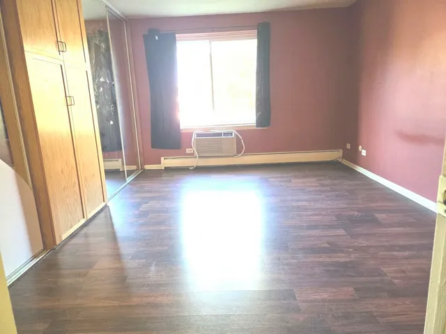 a view of a livingroom with wooden floor and window